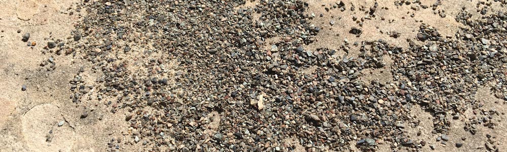 granules on ground from asphalt shingle roof