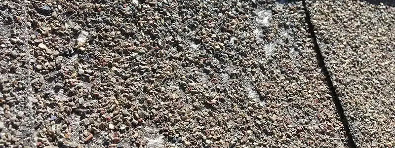 an asphalt shingle roof missing its granules