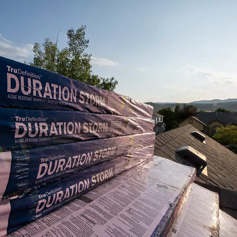 a close-up of a bundle of asphalt shingles on a roof