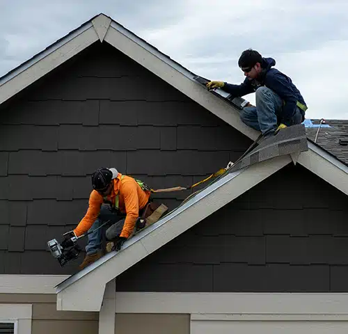 roofers installing new asphalt shingle roof