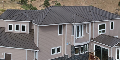 aerial view of house with new standing seam metal roof